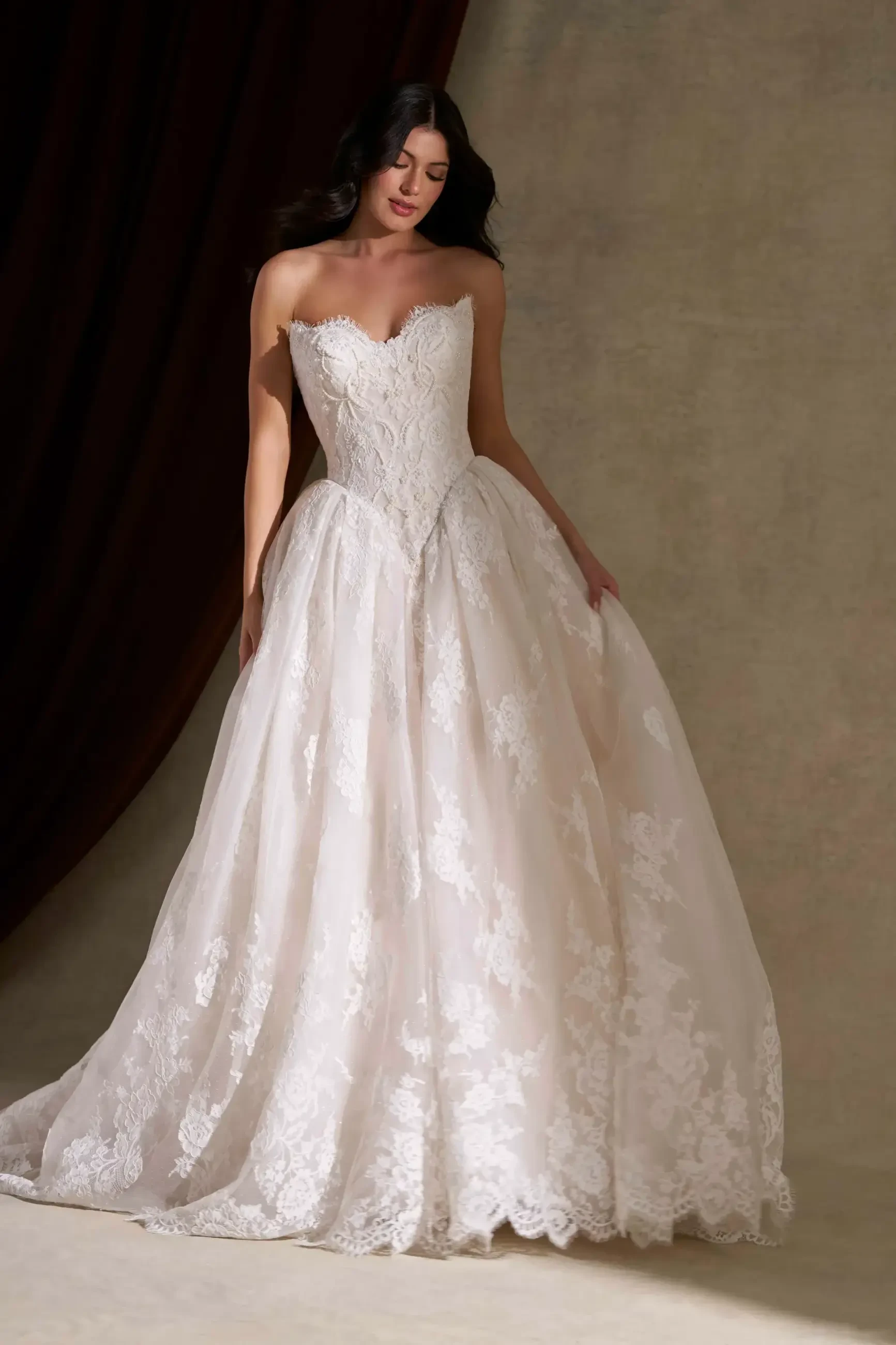 Model wearing a gown by Allure Couture